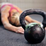 woman stretching and kettlebell