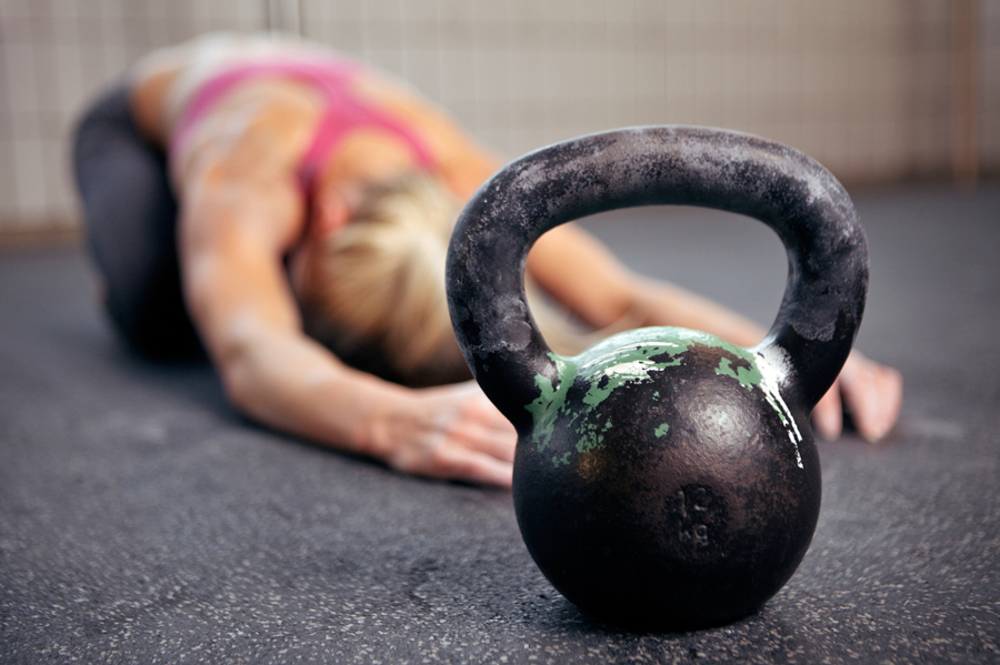 woman stretching and kettlebell